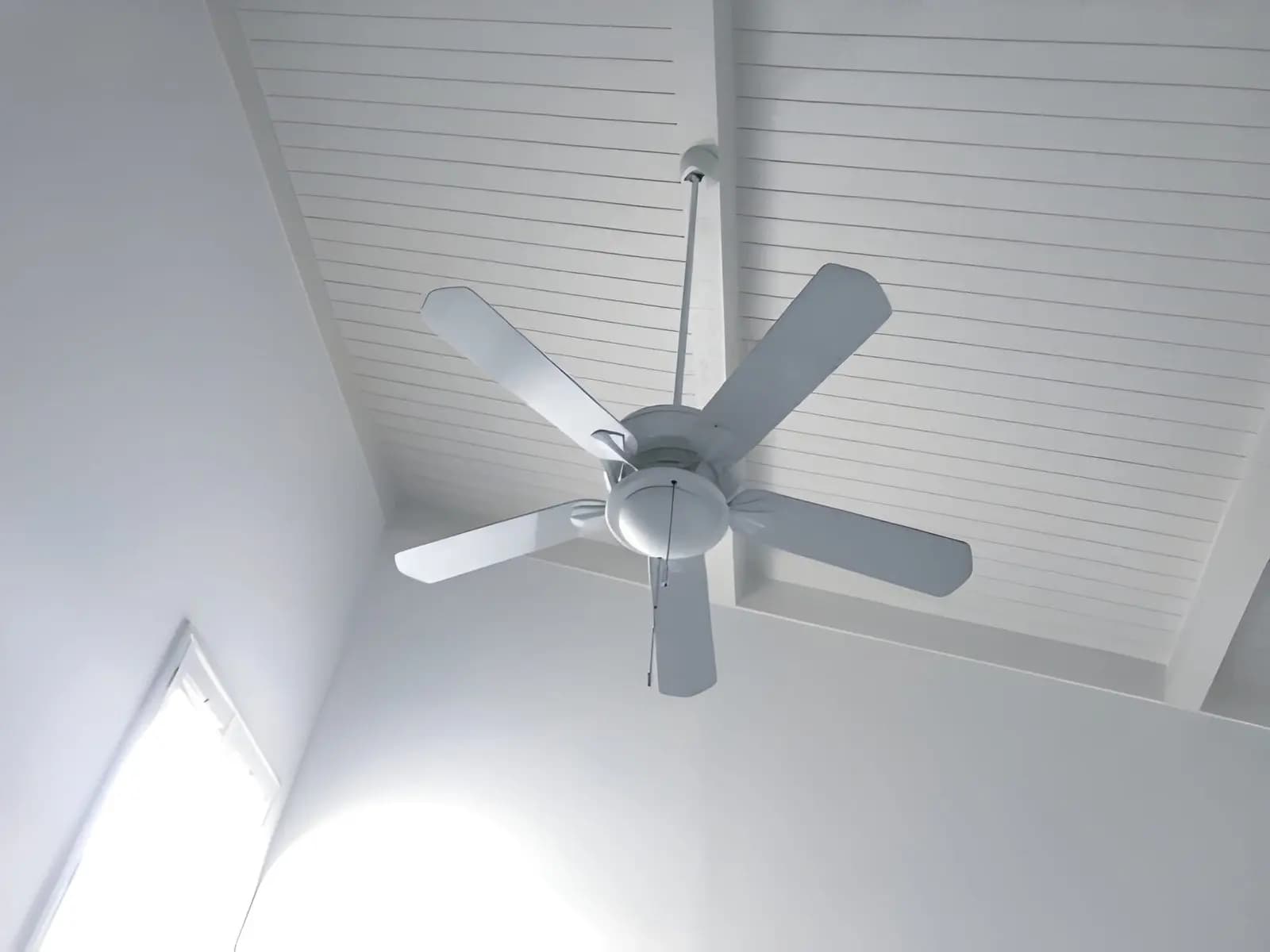 Ceiling fan installed on a bright, vaulted home ceiling